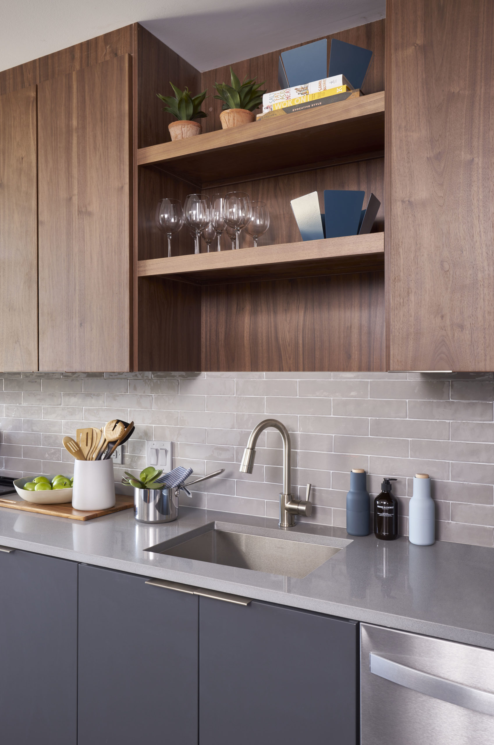 dark wood and gray cabinets white counter tops and stainless steel in modern vyv apartment