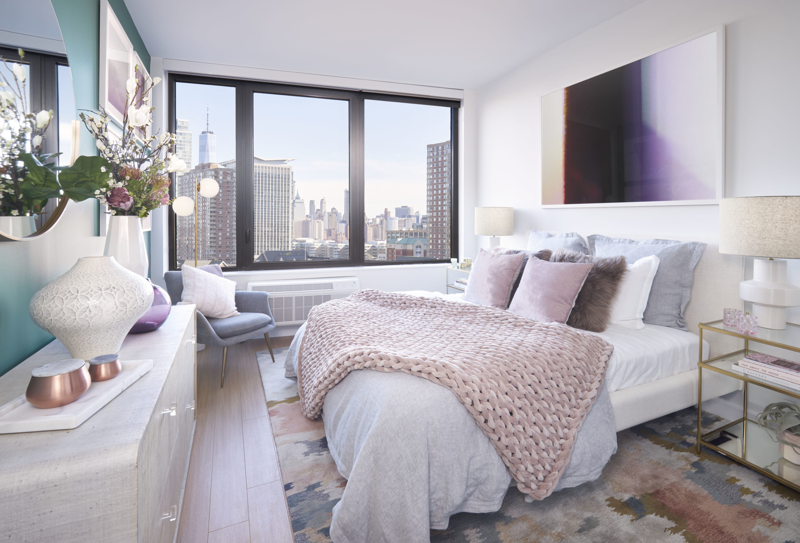 newport apartments in jersey city with wall to wall window and giant white bed